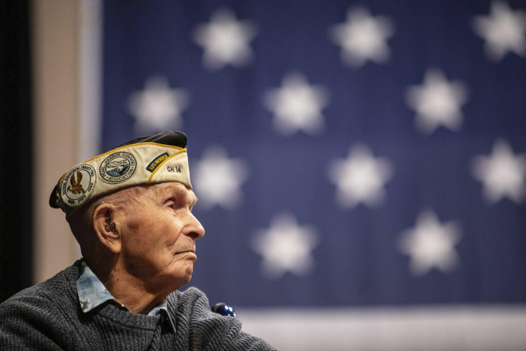 Pearl Harbor survivor Dick Higgins listens to a speaker during a ceremony at Bend High School in Bend, Ore., on Dec. 7, 2023, to honor him as well as those who died in the Dec. 7, 1941 attack on Pearl Harbor. Higgins, one of the few remaining survivors of the Japanese attack on Pearl Harbor, died Tuesday, March 19, 2024, at his home in Bend, Ore. He was 102. (Joe Kline/The Bulletin via AP)