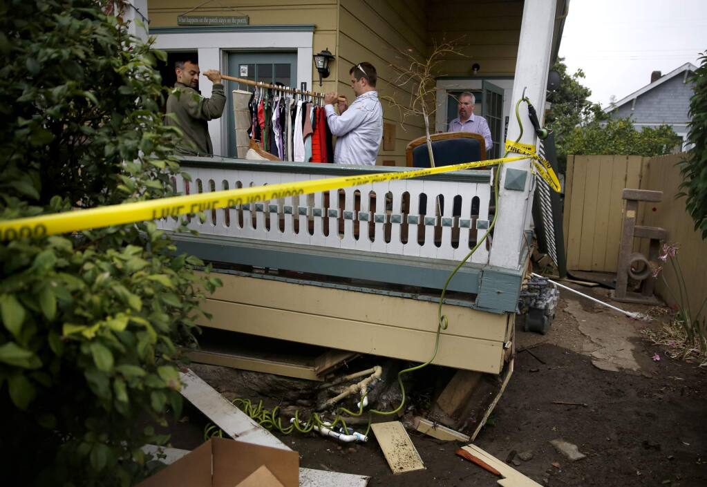 (From left)Matt Baldassano, Austin Gallion and Matthew Fitch help to remove the belongings of their friend Sarah Sandbek from her apartment on 4th Street after it was severely damaged during a 6.0 earthquake on Sunday, August 24, 2014 in Napa, California. (BETH SCHLANKER/ The Press Democrat)