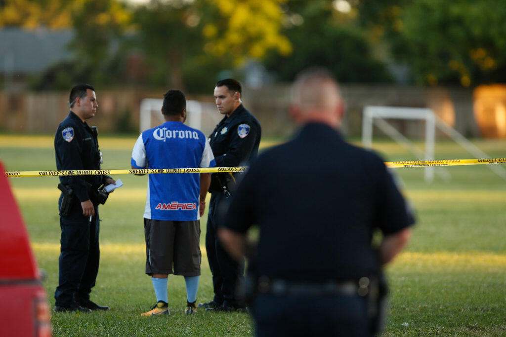 Santa Rosa Police officers interview a witness as they investigate the scene of a shooting at Jacobs Park, in Santa Rosa, California, on Wednesday, June 5, 2019. (Alvin Jornada / The Press Democrat)