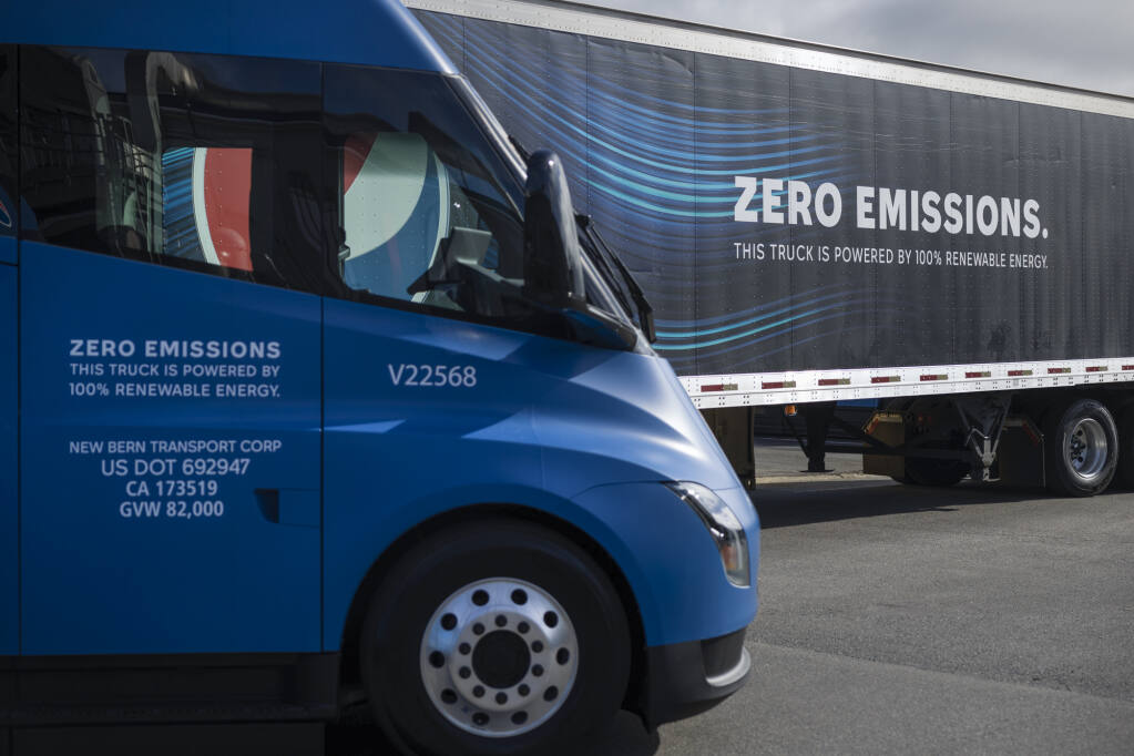 A fleet of Tesla trucks on display at PepsiCo Beverages North America's Sacramento facility on April 11, 2023. The company hosted an event to celebrate the arrival of 18 electric big rigs. by Miguel Gutierrez Jr., CalMatters