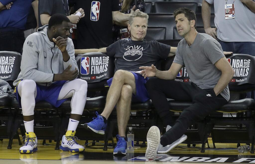 Golden State Warriors general manager Bob Myers, right, talks with forward Draymond Green, left, and head coach Steve Kerr during a team practice in Oakland, Wednesday, June 12, 2019. (AP Photo/Jeff Chiu)
