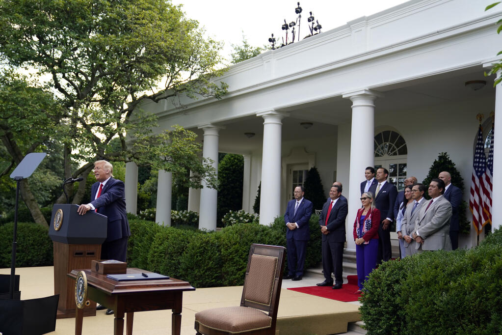President Donald Trump speaks before signing an executive order on the "White House Hispanic Prosperity Initiative," in the Rose Garden of the White House, Thursday, July 9, 2020, in Washington. (AP Photo/Evan Vucci)
