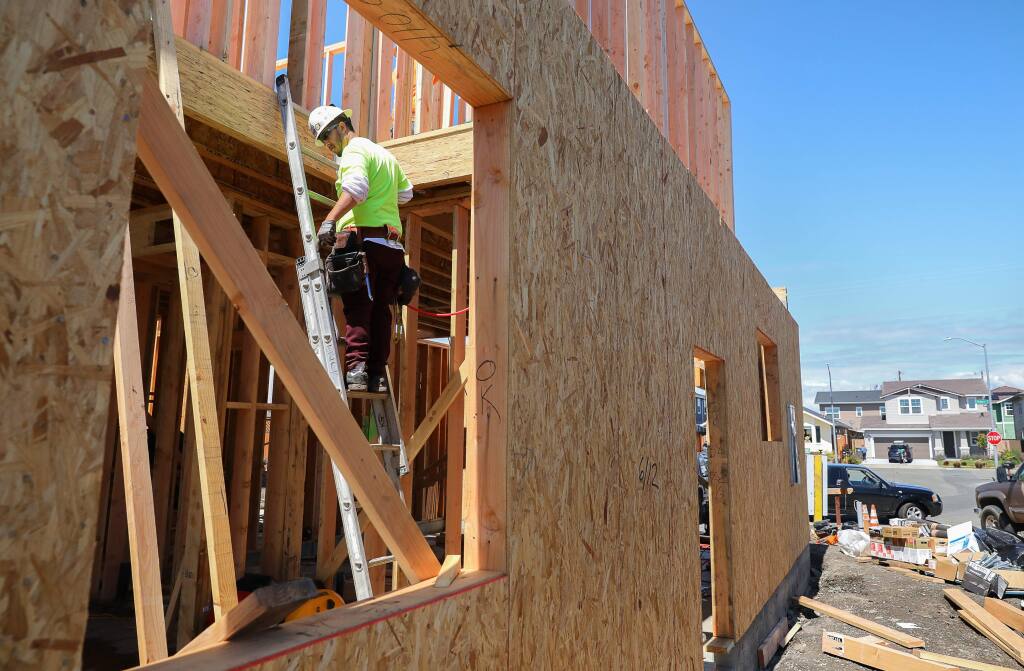 Matteo Gonzalez works on a home under construction on Jessica Place, in Santa Rosa on Tuesday, April 7, 2020. (Christopher Chung/ The Press Democrat)
