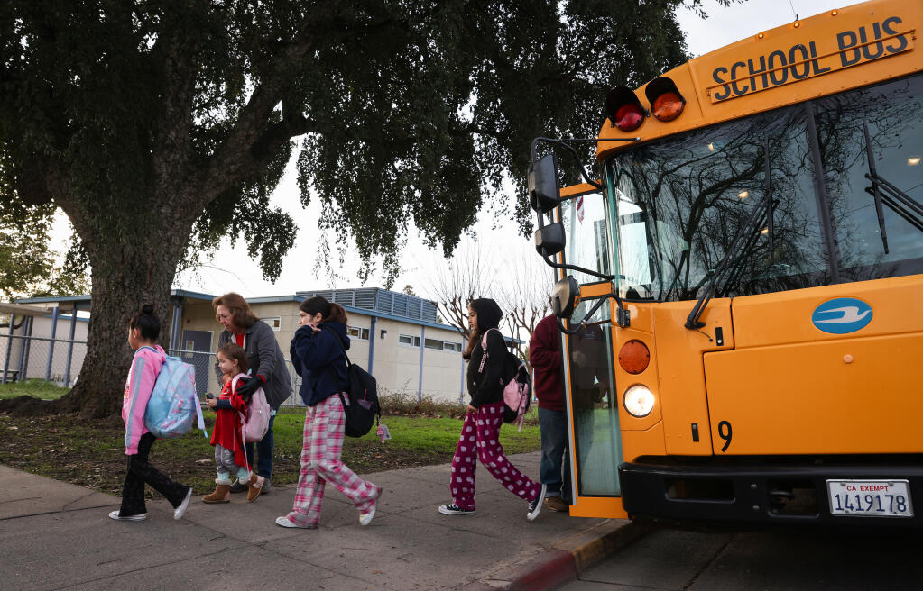 Students arrive at Sassarini Elementary School from a school bus in Sonoma, Friday, Feb. 9, 2024. (Christopher Chung / The Press Democrat)