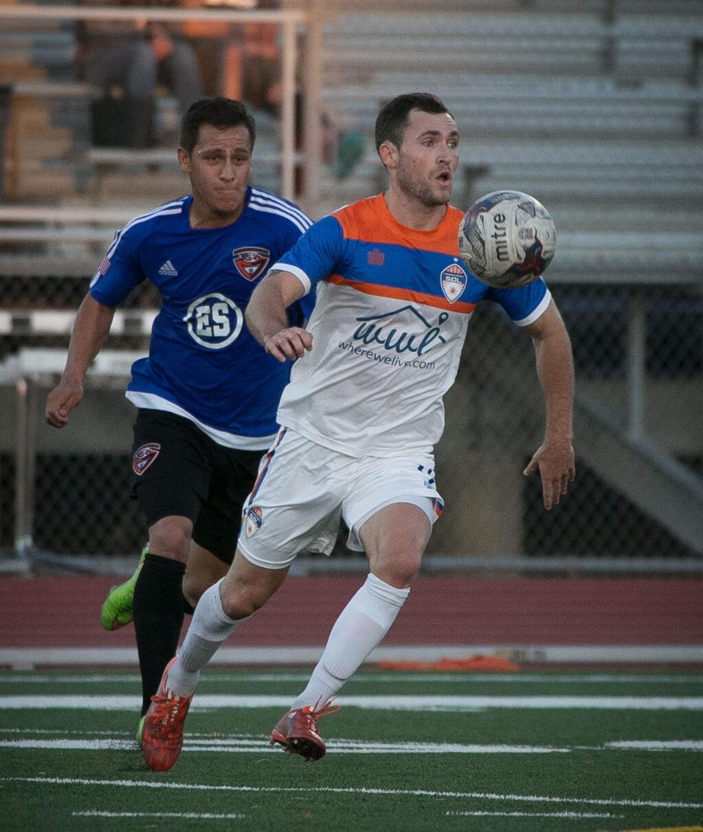 Sonoma County's Simon Wheatley takes the ball around a CD Aguiluchos defender during their National Premier Soccer League regional semifinal playoff match at Santa Rosa High School in Santa Rosa, Saturday, July 18, 2015. (Jeremy Portje / for The Press Democrat)