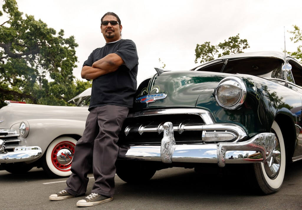 Juan Roman leans against his customized 1952 Chevrolet Business Coupe during a gathering of the Sonoma County Lowrider Council outside the Finley Community Center in Santa Rosa. The Sonoma County Lowrider Council is scheduled to host their annual Cinco de Mayo BBQ and Cruise at Doyle Park in Santa Rosa on Saturday, May 7. (Alvin Jornada / The Press Democrat)