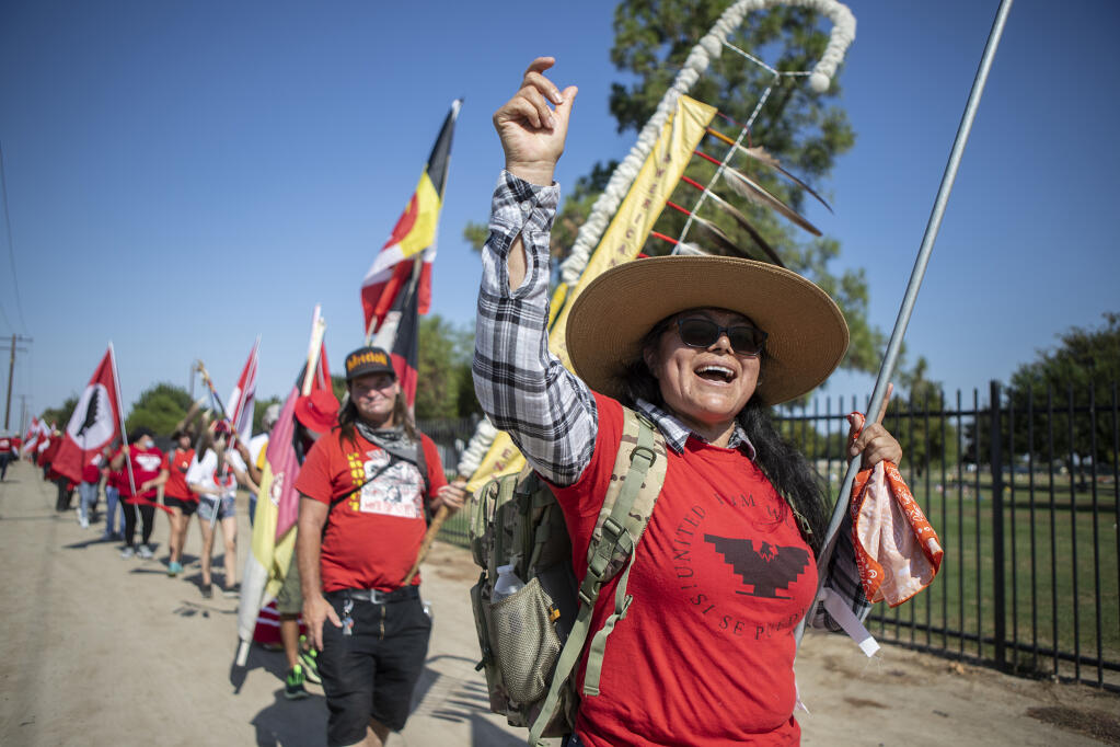 United Farm Workers member Veronica Mota leads marchers in chants through Delano in Aug. 3, 2022. Photo by Larry Valenzuela, CalMatters/CatchLight Local