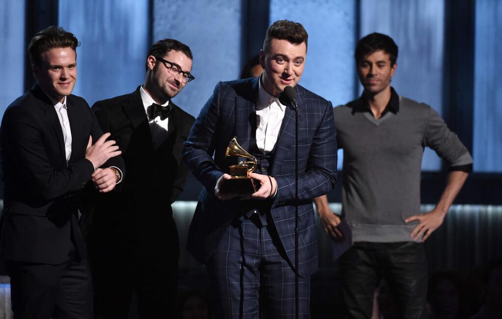 William Phillips, from left, James Napier and Sam Smith accept the award for song of the year for Stay With Me at the 57th annual Grammy Awards on Sunday, Feb. 8, 2015, in Los Angeles. (Photo by John Shearer/Invision/AP)