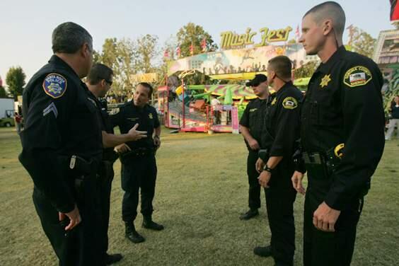 Santa Rosa police and Sonoma County sheriff's deputies meet before deploying for patrols at the Sonoma County Fair on Wednesday July 23, 2008. (PD FILE)