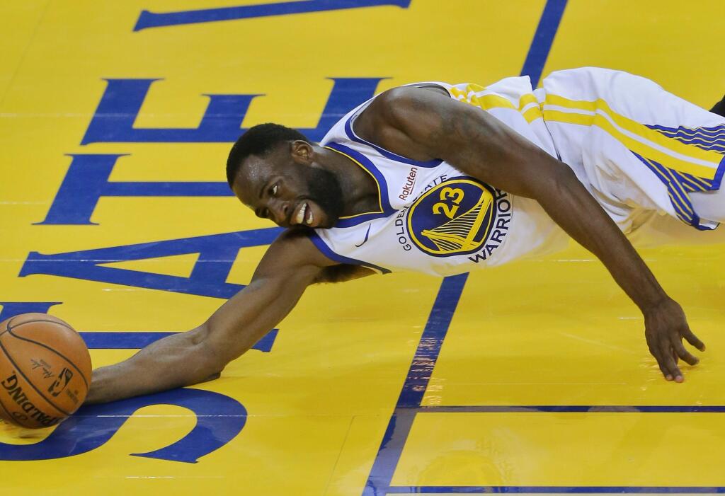Golden State Warriors forward Draymond Green dives in an attempt to save the ball from going out of bounds against the Portland Trail Blazers during game 1 of the NBA Western Conference Finals in Oakland on Tuesday, May 14, 2019. (Christopher Chung/ The Press Democrat)