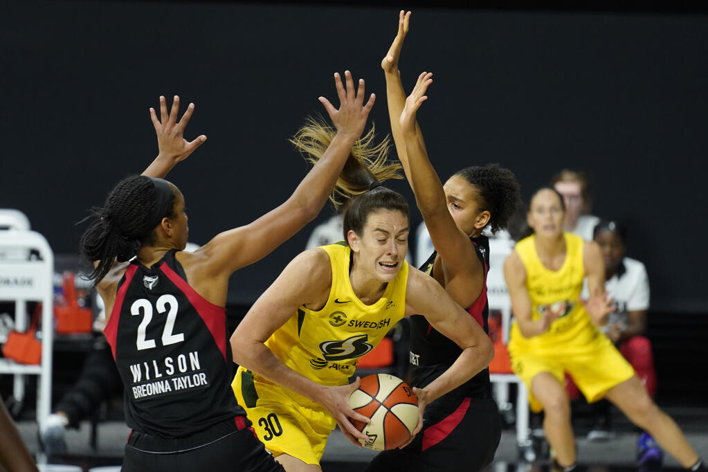 Seattle Storm forward Breanna Stewart (30) gets between Las Vegas Aces center A'ja Wilson (22) and forward Cierra Burdick (11) during the second half of Game 3 of basketball's WNBA Finals Tuesday, Oct. 6, 2020, in Bradenton, Fla.  (AP Photo/Chris O'Meara)