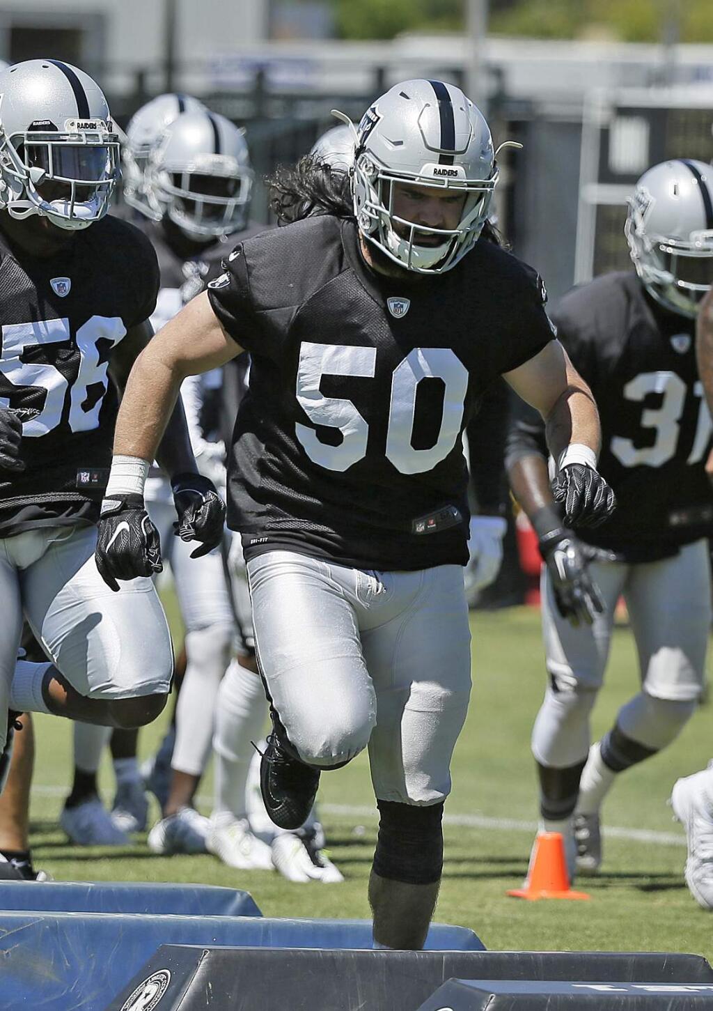 In this July 29, 2016, file photo, Oakland Raiders linebacker Ben Heeney (50) runs through obstacles during practice at the team's training camp in Napa. (AP Photo/Eric Risberg, File)