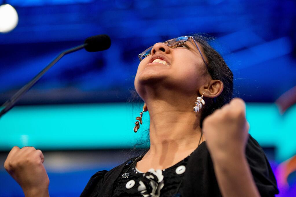 Ankita Vadiala, 13, of Manassas, Va. reacts positively as she is given the word 'billable' to spell during the semifinals of the 2015 Scripps National Spelling Bee, Thursday, May 28, 2015, in Oxon Hill, Md. Vadiala spelled the word correctly. (AP Photo/Andrew Harnik)