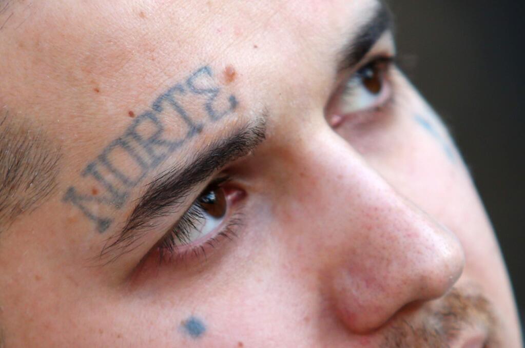 A tattoo over Chris McDaniel's right eyebrow signifies his gang affiliation. (Christopher Chung/ The Press Democrat)