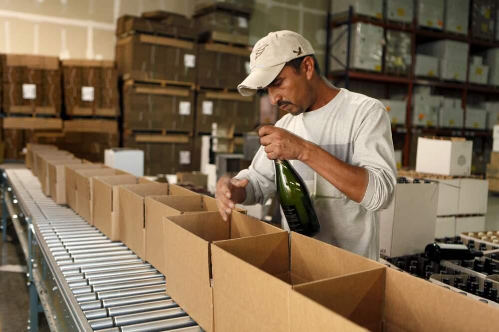 Eliseo Tellez boxes wine bottles at the Wineshipping distribution center in Sonoma, California on Thursday, July 28, 2011. (BETH SCHLANKER/ The Press Democrat)