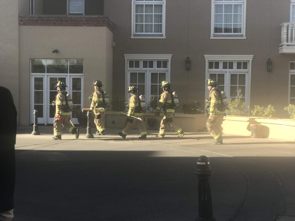 Firefighters enter the smoking Drury Plaza Hotel in Santa Fe, New Mexico. (Photo by Ann DuBay)