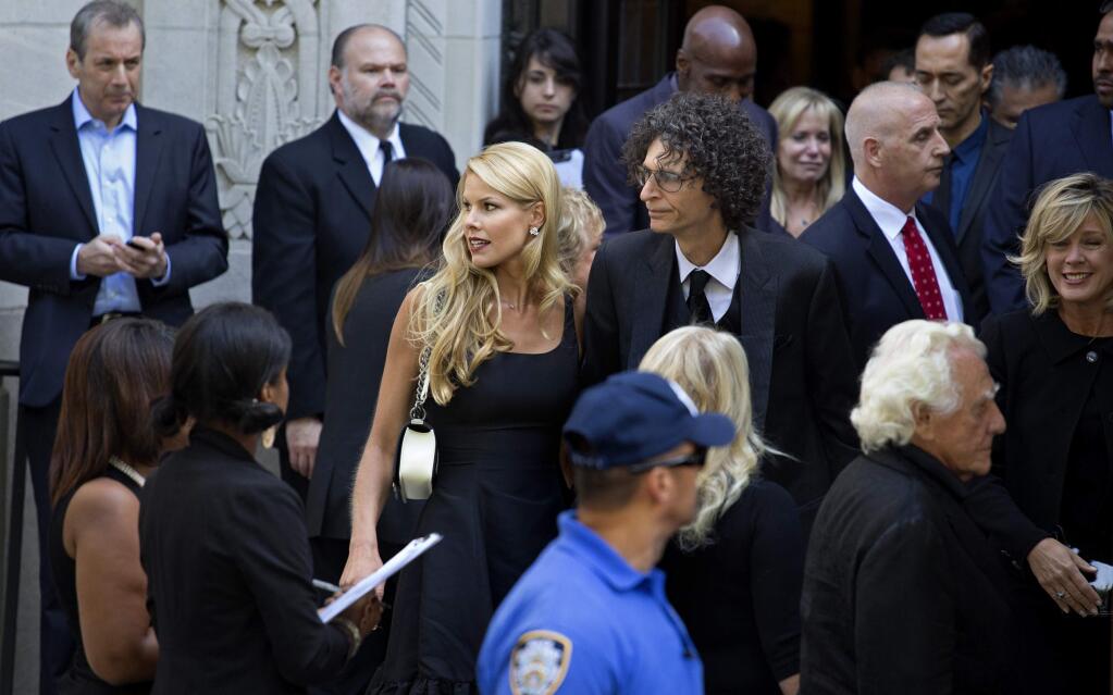 Howard Stern, center right, and his wife Beth depart a funeral service for comedian Joan Rivers at Temple Emanu-El in New York Sunday, Sept. 7, 2014. Rivers died Thursday at 81. (AP Photo/Craig Ruttle)