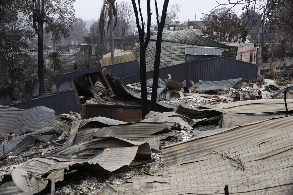 Houses are flattened at Conjola Park, Australia, Sunday, Jan. 5, 2020, after recent wildfires ripped through the community. The deadly wildfires, which have been raging since September, have already burned about 5 million hectares (12.35 million acres) of land and destroyed more than 1,500 homes. (AP Photo/Rick Rycroft)