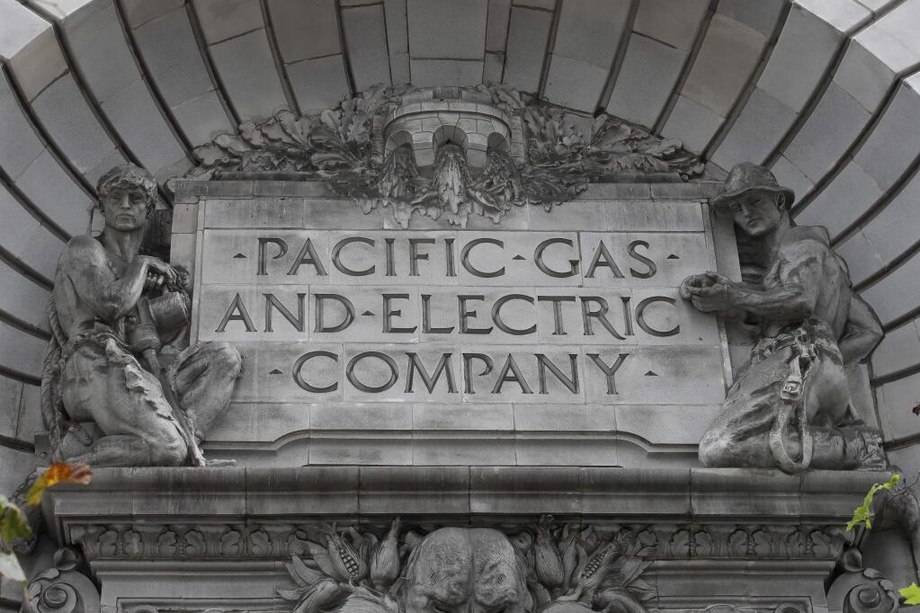 FILE - In this April 16, 2020, file photo, a Pacific Gas & Electric sign is displayed on the exterior of a PG&E building in San Francisco. (AP Photo/Jeff Chiu, File)