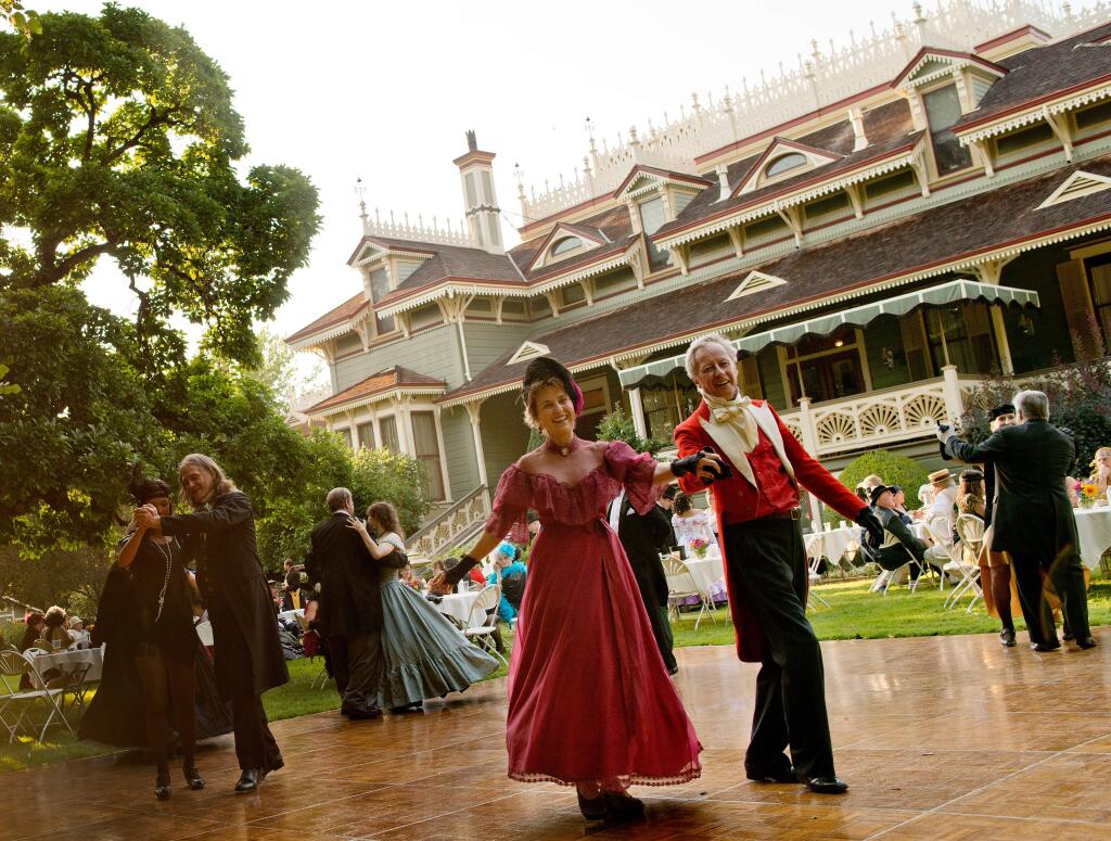 Paula Rector, center, and Christopher Schilling dance in their period costumes during the Historical Ball at McDonald Mansion, to benefit the Santa Rosa Rural Cemetery, in Santa Rosa, Calif., on July 20, 2013. (Alvin Jornada / For The Press Democrat)