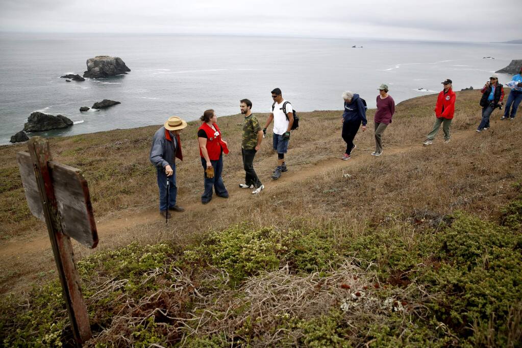 Coastal conservationist Bill Kortum, left, and his family met with members of an all-Spanish speaking Lions Club from the Roseland area at the head of Kortum Trail on Saturday, September 20, 2014 near Jenner, California. (BETH SCHLANKER/ The Press Democrat)