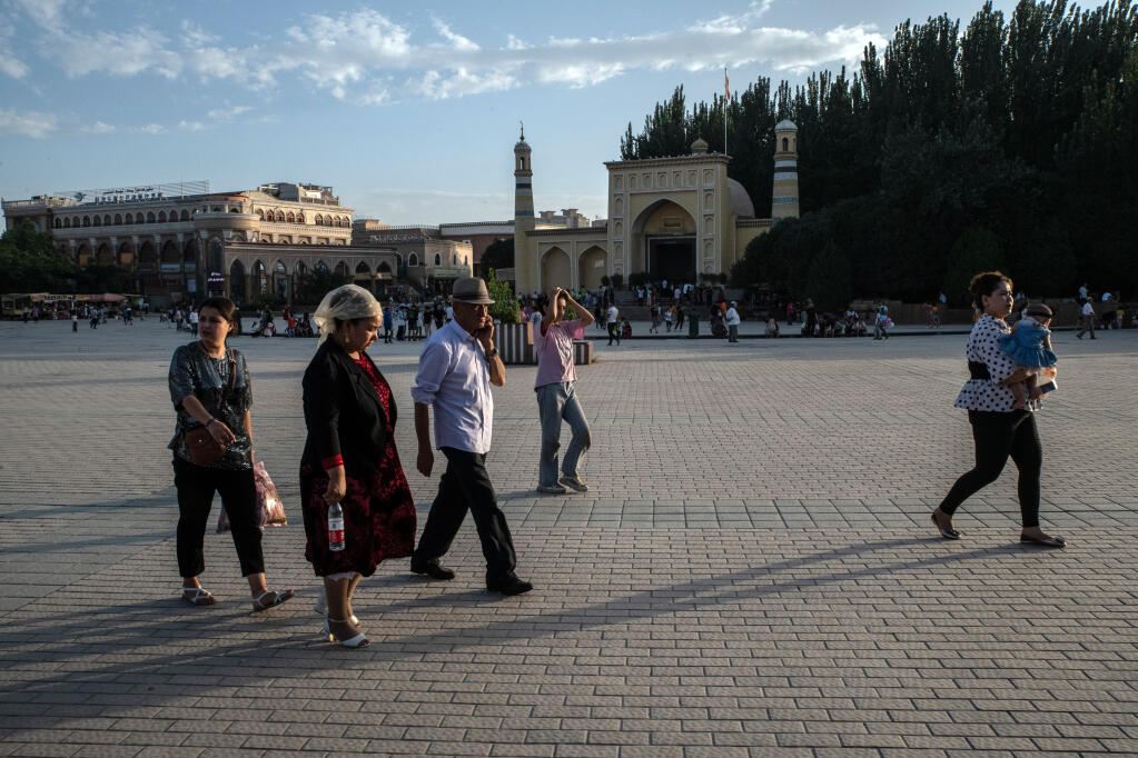 People outside the Id Kah Mosque in Kashgar in the Xinjiang region of China on Aug. 7, 2019. A movie is part of Beijing’s wide-ranging new propaganda campaign to push back on sanctions and criticism of its oppression of the Uyghurs. (The New York Times/Giles Sabrie)