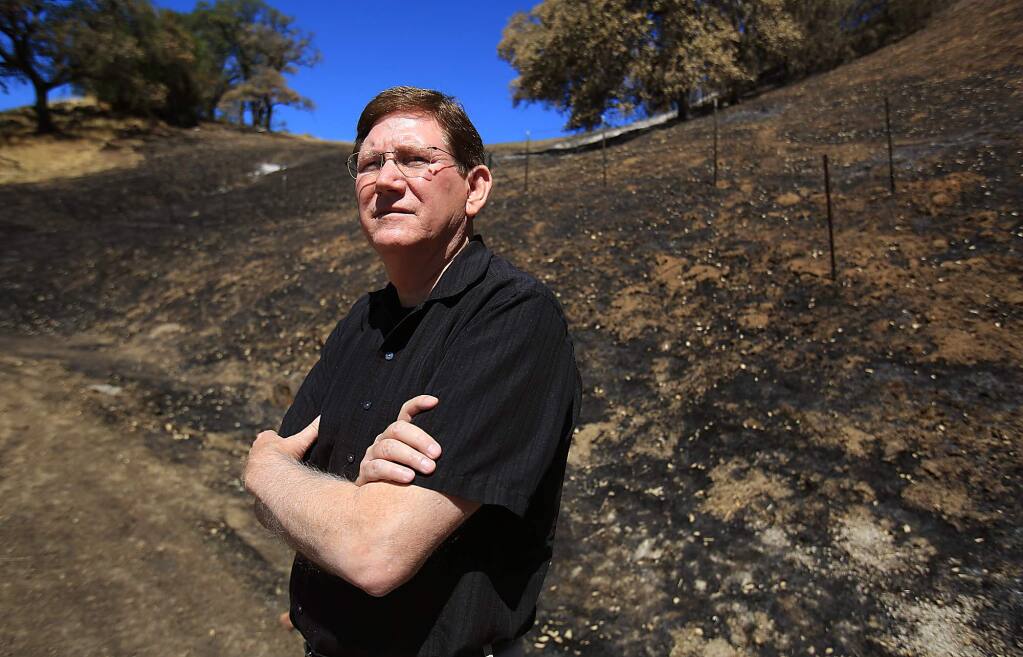 Burton Jernigan an agent with State Farm Insurance in Lower Lake, at the Rocky fire burn area, Friday Aug. 14, 2015. (Kent Porter / Press Democrat) 2015