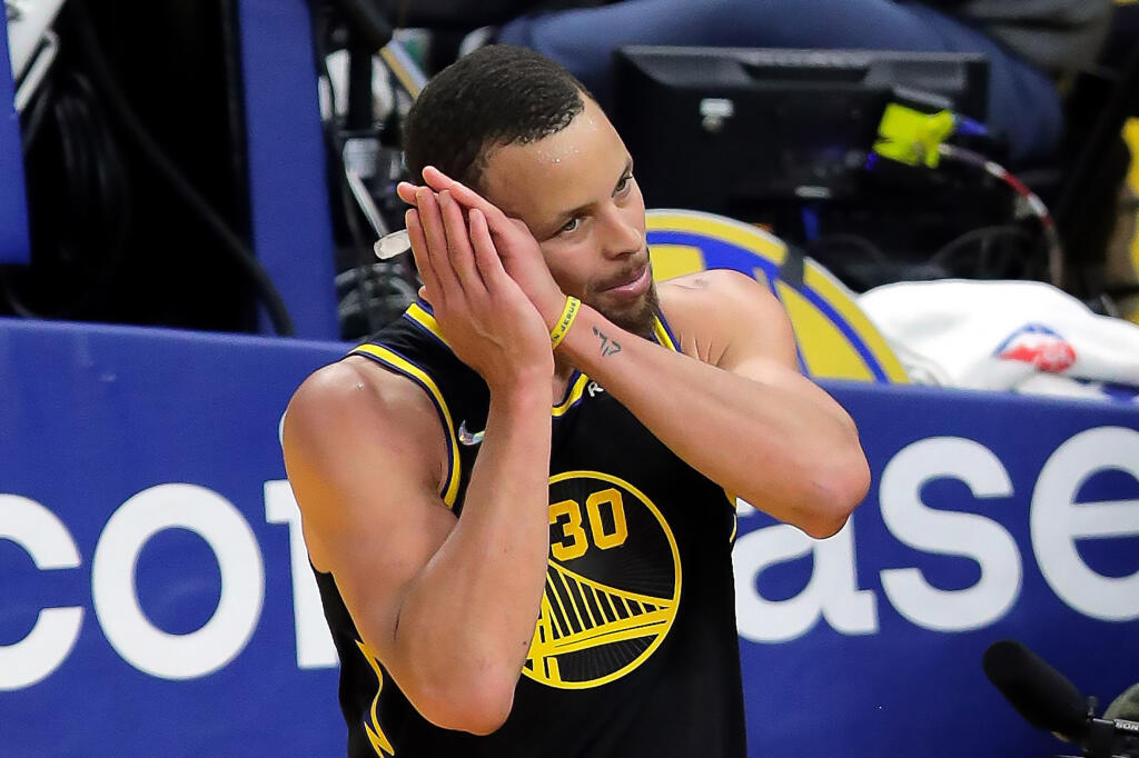 The Golden State Warriors’ Stephen Curry makes a sleeping gesture late in the second half of Game 5 of their first-round playoff series against the Denver Nuggets on Wednesday, April 27, 2022, in San Francisco. (Carlos Avila Gonzalez / San Francisco Chronicle)