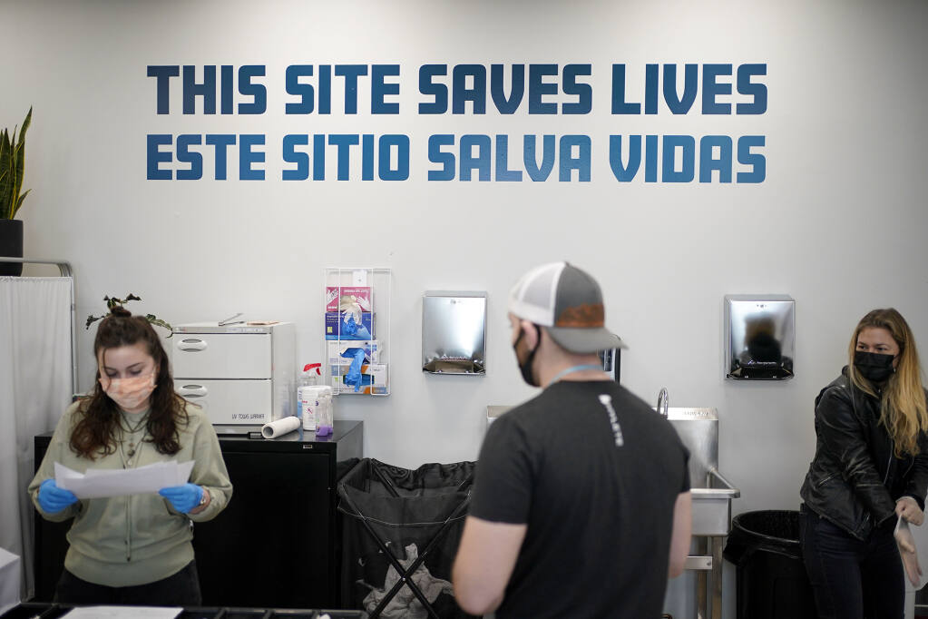 A sign on a wall reads "This site save lives" in Spanish and English at an overdose prevention center at OnPoint NYC in New York on Feb. 18, 2022. Photo by Seth Wenig, AP