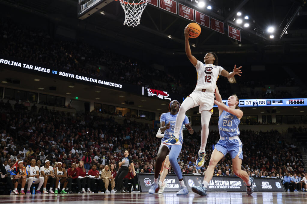 South Carolina guard MiLaysia Fulwiley drives to the basket ahead of North Carolina forward Maria Gakdeng and guard Lexi Donarski, right, during the second half of a second-round game in the women’s NCAA Tournament in Columbia, South Carolina, Sunday, March 24, 2024. (Nell Redmond / ASSOCIATED PRESS)
