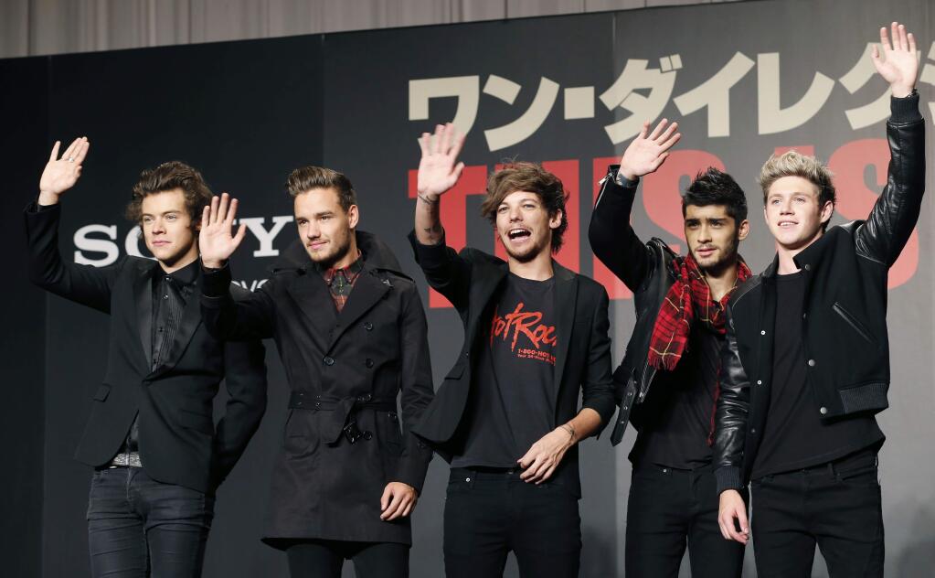 FILE- In this March 25, 2015 file photo, members of One Direction, from left, Harry Styles, Liam Payne, Louis Tomlinson, Zayn Malik and Niall Horan, wave during an event to promote their film 'One Direction: This Is US,' in Makuhari, near Tokyo. A British newspaper has reported Monday, Aug. 24, 2015, the band members would go separate ways after finishing a tour this autumn and promoting their fifth album. Publicist Simon Jones says he wont comment on speculation that the group will take a hiatus starting in March. (AP Photo/Koji Sasahara, File)