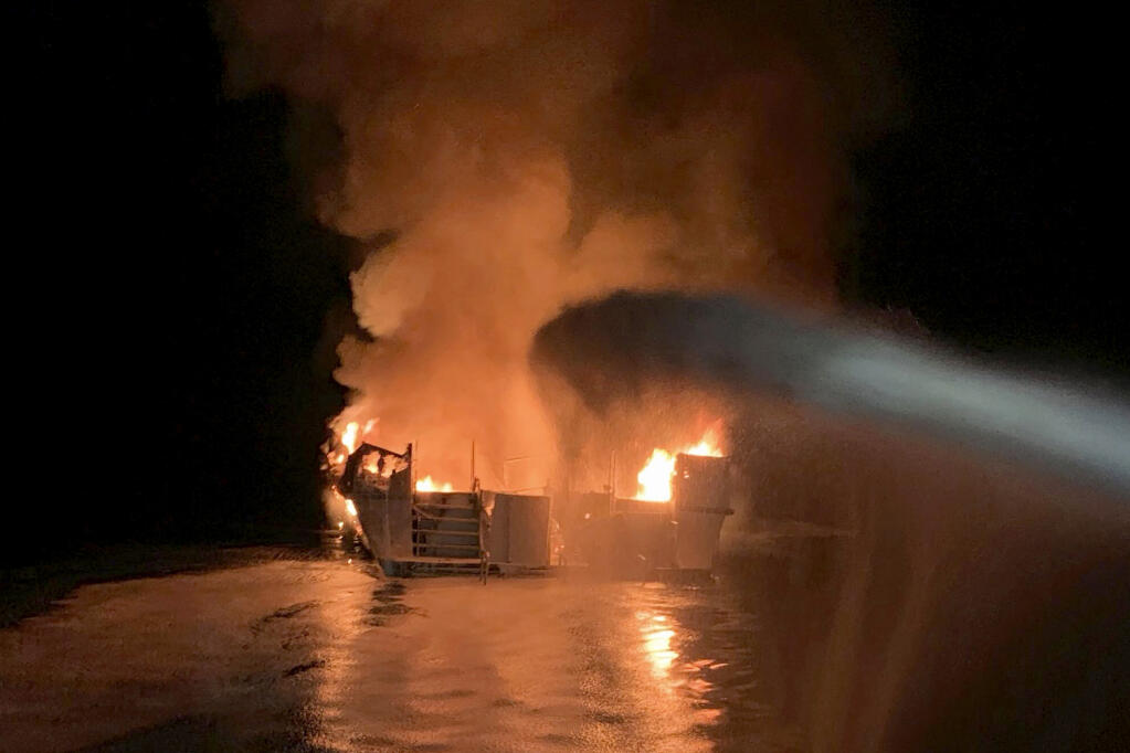 FILE - In this Sept. 2, 2019, file photo provided by the Ventura County Fire Department, firefighters respond to a fire aboard the Conception dive boat fire in the Santa Barbara Channel off the coast of Southern California. The Coast Guard signaled Wednesday, Feb. 10, 2021, that it would undertake a series of recommended safety reforms for passenger vessels in the wake of a 2019 scuba dive boat fire that killed 34 people off the California coast, but a top transportation official cautioned that any changes might take years to enact. The blaze broke out aboard the Conception during the final night of a three-day Labor Day weekend scuba diving excursion near Santa Cruz Island off Santa Barbara. The tragedy marked the deadliest marine disaster in California in modern history. (Ventura County Fire Department via AP, File)