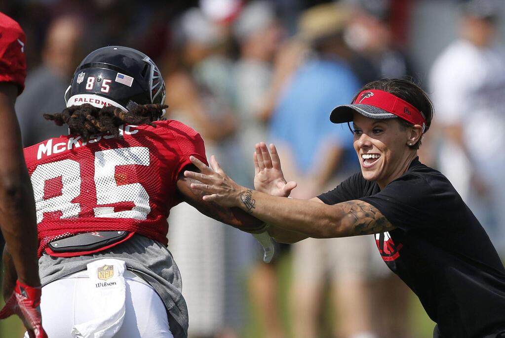 Atlanta Falcons wide receiver J.D. McKissic (85) works with coaching intern Katherine Sowers during NFL football practice Saturday, July 30, 2016, in Flowery Branch, Ga. (AP Photo/John Bazemore)
