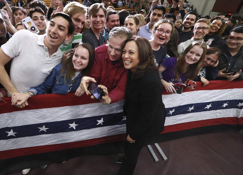 U.S. Senator Kamala D. Harris, D-California, pauses for a selfie with supporters while working the crowd after her speech while holding a campaign rally at Morehouse College on Sunday, March 24, 2019, in Atlanta. The Democratic candidate for president is at least the fifth presidential candidate to visit Georgia in the 2020 cycle. (Curtis Compton/Atlanta Journal-Constitution via AP)