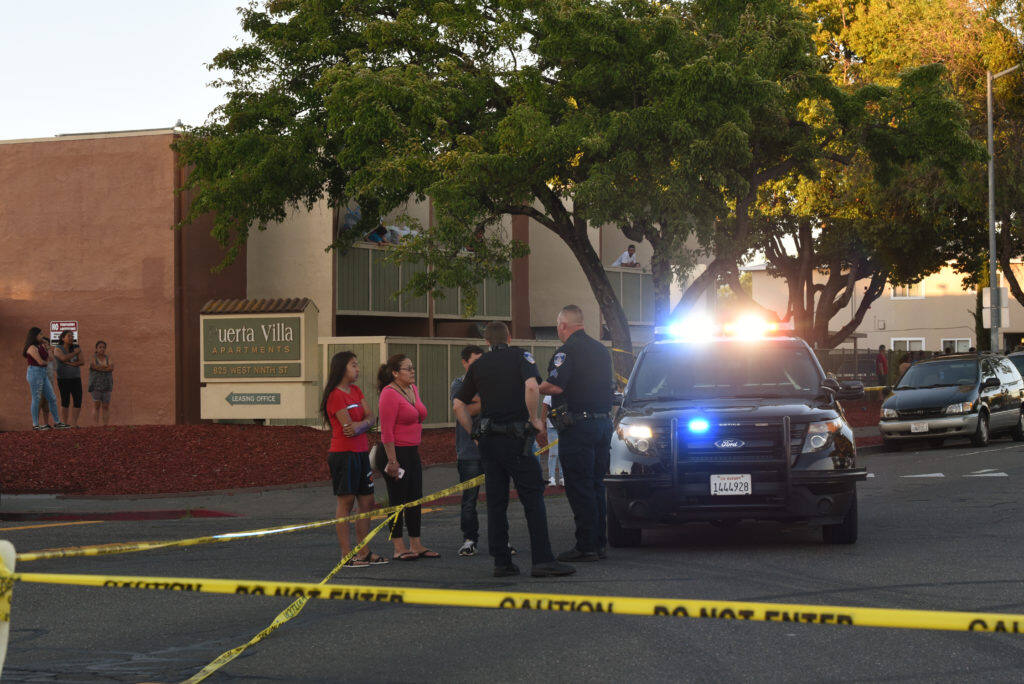 Santa Rosa police officers talking to local residents after a shooting took place at Jacobs Park on W. 9th Street in Santa Rosa, California. June 5, 2019.(Photo: Erik Castro/for The Press Democrat)