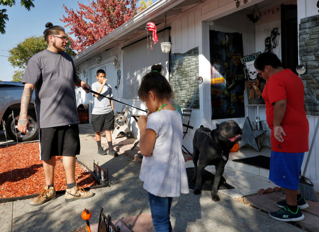 Lorenzo Martinez, left, and his family prepare to evacuate after receiving mandatory evacuation orders due to the Kincade Fire, in Windsor, California, on Saturday, Oct. 26, 2019. (Alvin Jornada / The Press Democrat file, 2019)
