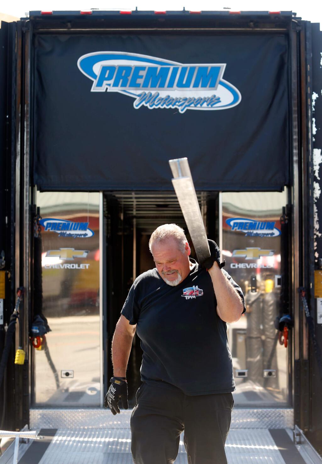 Premium Motorsports crewmember Willy Evernham of Mooresville, NC unloads equipment from the transporter in preparation for this weekend's NASCAR Monster Energy Cup Series Toyota/Save Mart 350 race at Sonoma Raceway, in Sonoma, California, on Thursday, June 21, 2018. (Alvin Jornada / The Press Democrat)