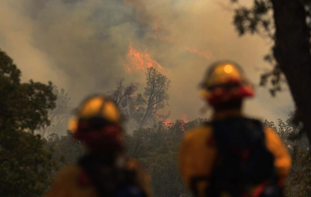 Flames run up a steep hillside as the Jerusalem fire burns in Lake County. (KENT PORTER / Press Democrat)