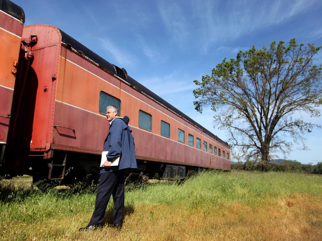 Mitch Stogner, executive director of the North Coast Railroad Authority, looks over a rail car, near Asti Winery, on Tuesday, April 19, 2011. The rail car is part of a set of nine cars, which will be auctioned off by the North Coast Railroad Authority.