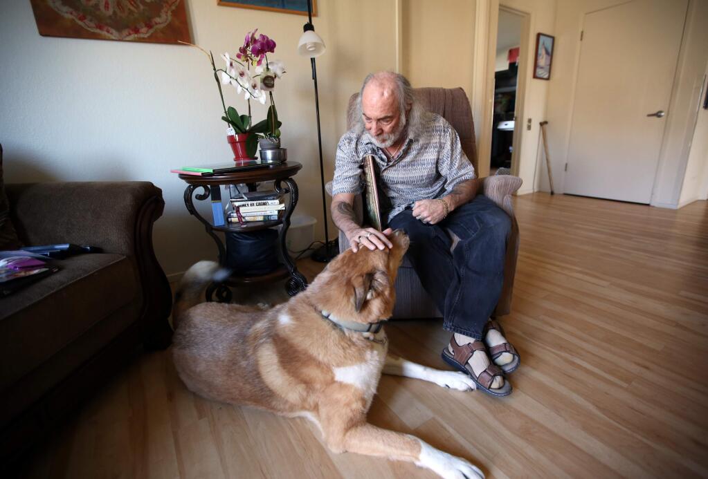 Bar Ponneck with his service dog Duke in his Windsor home, Thursday, March 5, 2015. (CRISTA JEREMIASON / The Press Democrat)