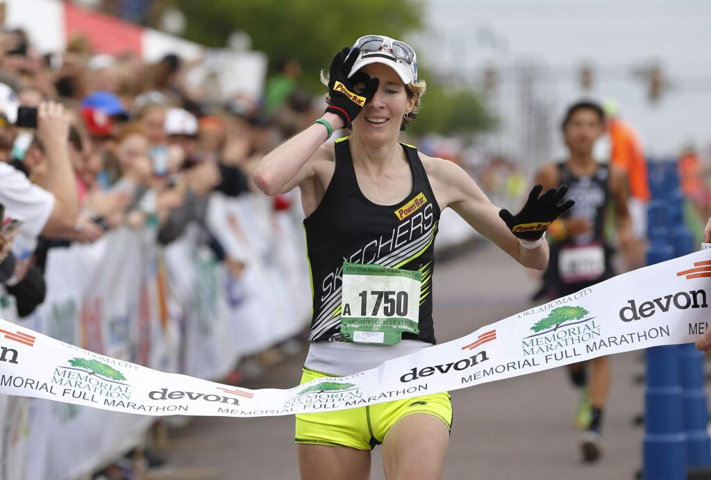 Camille Herron crosses the finish line of the 15th annual Oklahoma City Memorial Marathon for her third win in the women's division of the event in Oklahoma City, Sunday, April 26, 2015. Herron will race in the Lake Sonoma 50 on Saturday, April 13, 2019. (AP Photo/Sue Ogrocki)
