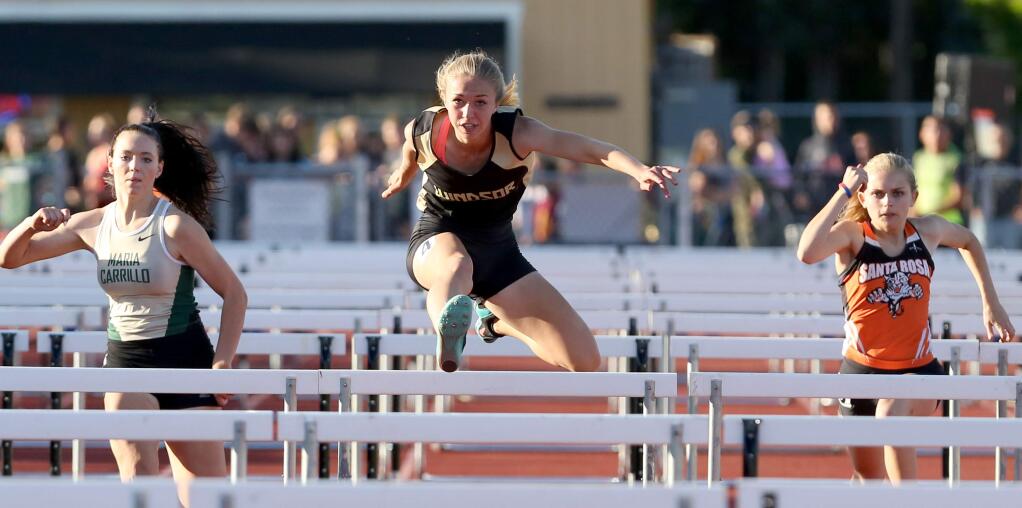 Windsor's Maddie Call, center, won the 100m High Hurdles during the North Bay League track finals held at Windsor High School, Friday, May 15, 2015. (Crista Jeremiason / The Press Democrat)