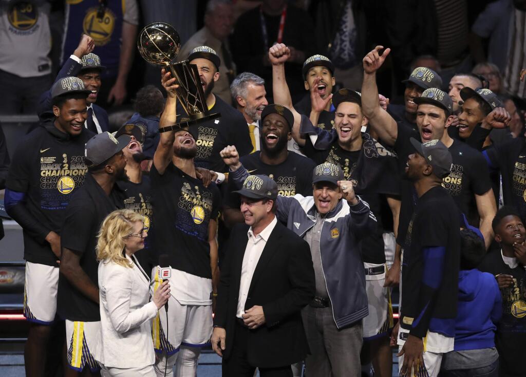 FILE - In this Friday, June 8, 2018, file photo, the Golden State Warriors celebrate after defeating the Cleveland Cavaliers 108-85 in Game 4 of basketball's NBA Finals to win the NBA championship, in Cleveland. The three-time NBA champion Golden State Warriors are the fourth team to be honored as Sports Illustrated's Sportsperson of the Year, the magazine announced Monday, Dec. 10, 2018. (AP Photo/Carlos Osorio, File)