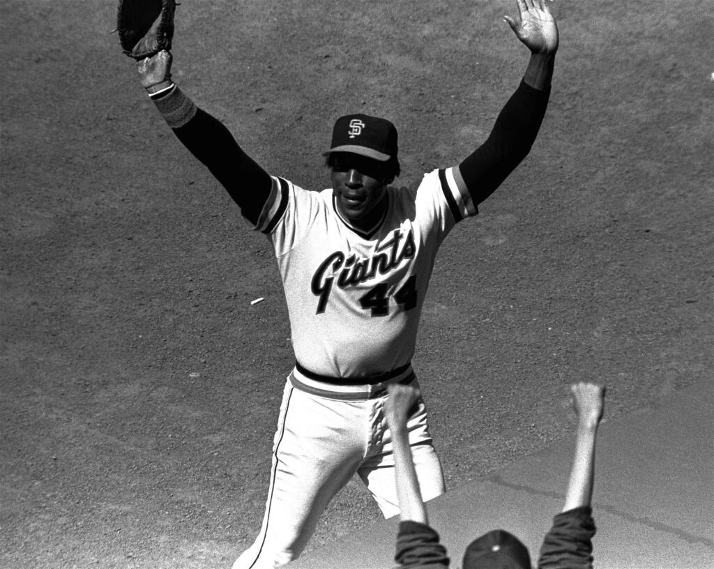 FILE - In this July 3, 1980, file photo, San Francisco Giants' Willie McCovey raises his hands in salute to the cheering crowd after he was replaced in the lineup in the team's baseball game with the Cincinnati Reds in San Francisco. It was the last home appearance before retirement for the popular veteran. McCovey, the sweet-swinging Hall of Famer nicknamed 'Stretch' for his 6-foot-4 height and those long arms, has died. He was 80. The San Francisco Giants announced his death, saying the fearsome hitter passed “peacefully” Wednesday afternoon, Oct. 31, 2018, “after losing his battle with ongoing health issues.” (AP Photo, File)
