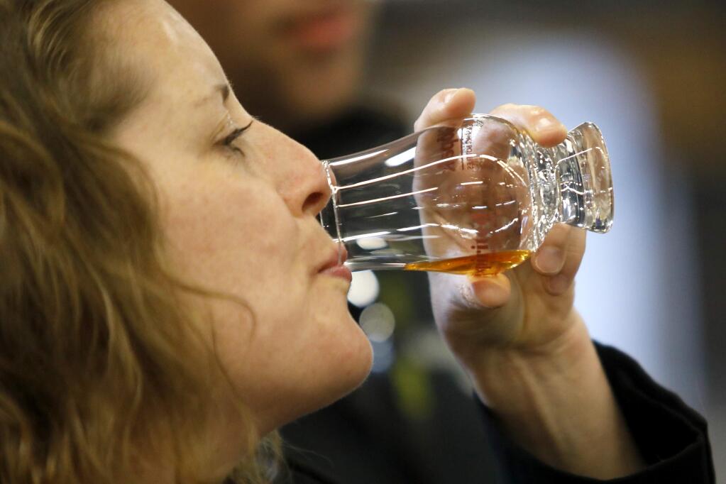 Halley Osborne samples the Straight Wheat Whiskey from Spirit Works Distillery during the Spirited International Spirits Trade Tasting and Show at the Grace Pavilion at Sonoma County Fairgrounds in Santa Rosa, on Tuesday, February 27, 2018. (BETH SCHLANKER/ The Press Democrat)