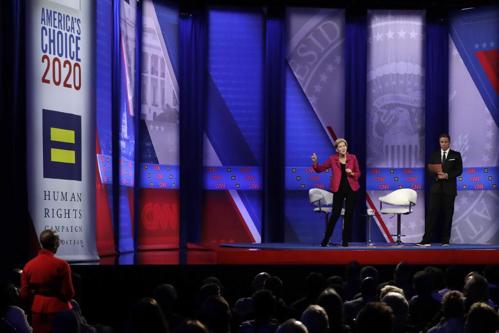 Democratic presidential candidate Sen. Elizabeth Warren, D-Mass., speaks as CNN moderator Chris Cuomo, right, listens during the Power of our Pride Town Hall Thursday, Oct. 10, 2019, in Los Angeles. The LGBTQ-focused town hall featured nine 2020 Democratic presidential candidates. (AP Photo/Marcio Jose Sanchez)