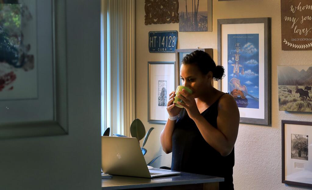 New mom Stephanie Meyer, sips her morning tea as she works from her home office in Santa Rosa, Friday, May 10, 2019. (Kent Porter / The Press Democrat) 2019