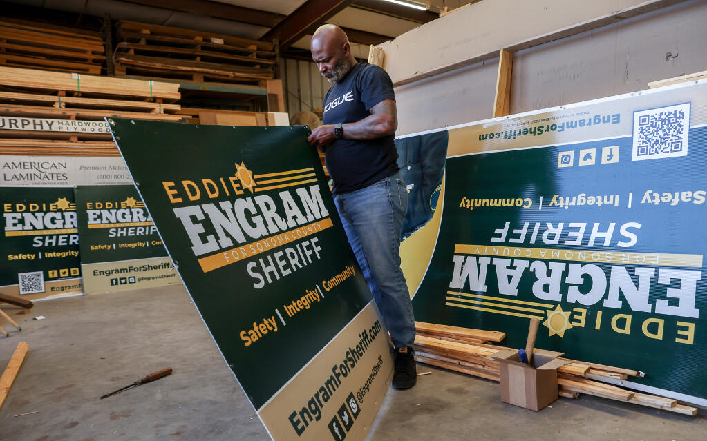 Sonoma County Assistant Sheriff Eddie Engram dismantles his campaign signs in Santa Rosa on Thursday, June 23, 2022.  Engram was elected as Sonoma County Sheriff and will take office in January 2023.  (Christopher Chung/The Press Democrat)