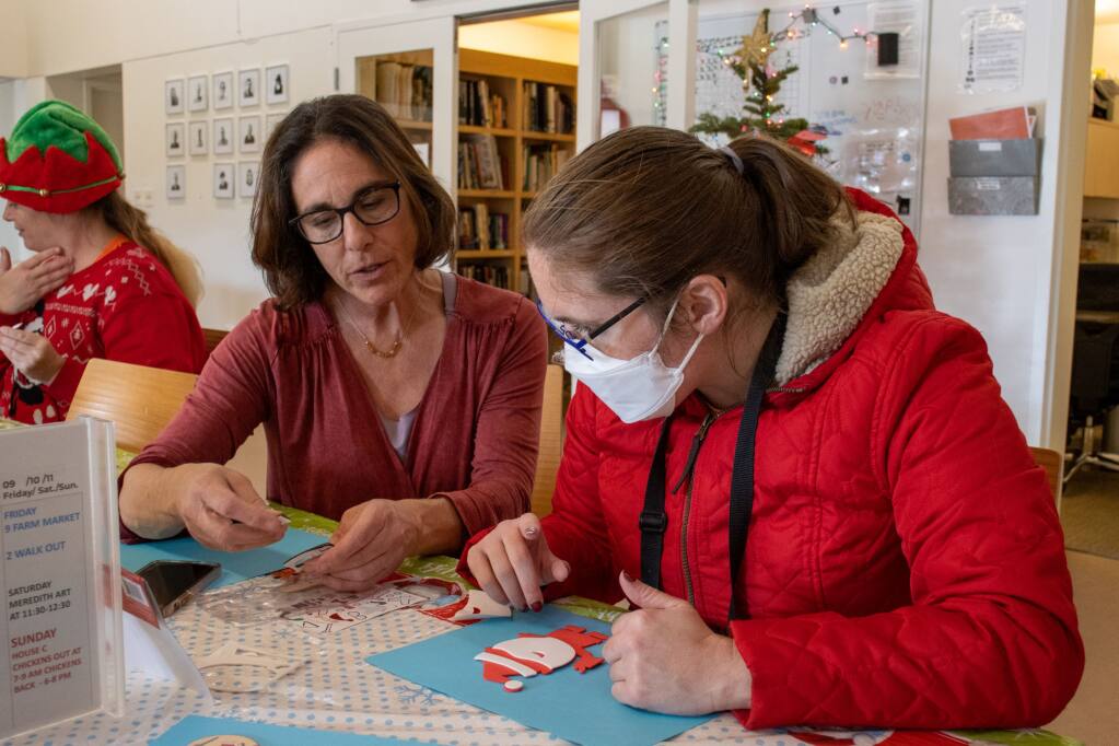 Danielle Zarosi (left), enrichment manager at Sweetwater Spectrum, helps resident Becky Cleveland create her Santa ornament on Tuesday, Nov. 6, 2022. (Photo by Liberty Olhava)