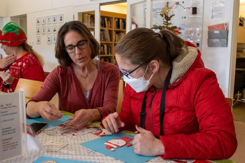 Danielle Zarosi (left), enrichment manager at Sweetwater Spectrum, helps resident Becky Cleveland create her Santa ornament on Tuesday, Nov. 6, 2022. (Photo by Liberty Olhava)